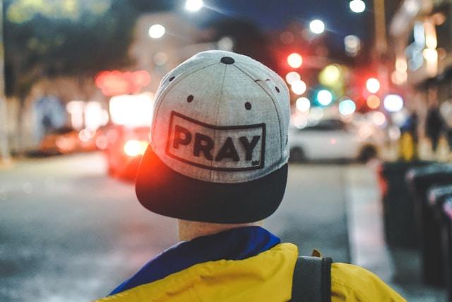 Gray baseball cap embroidered with PRAY, illustrating how to pray with the STRONG prayer method