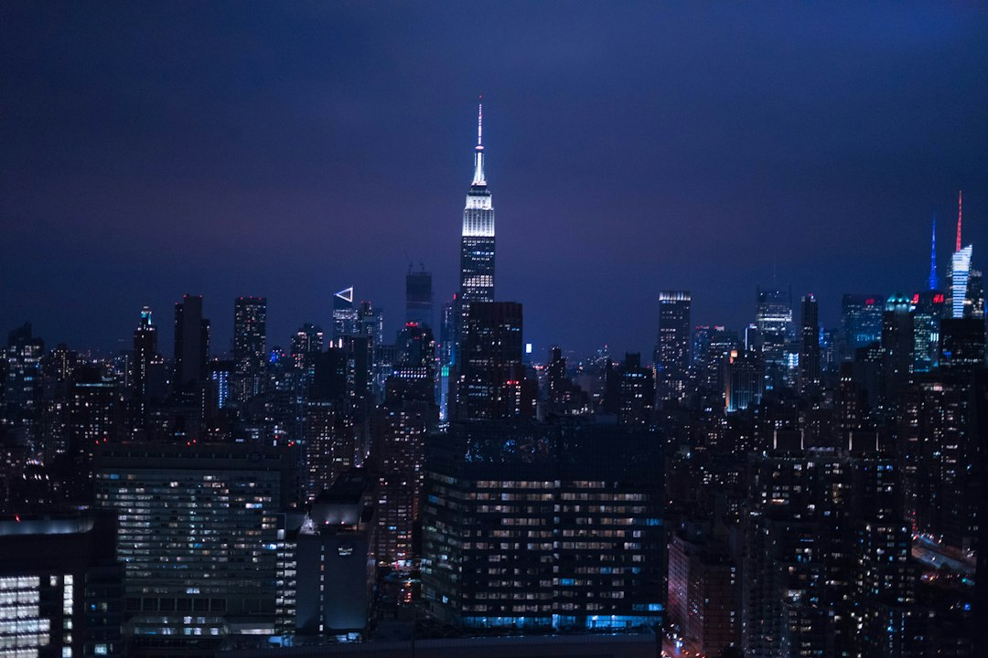 Aerial view of city lights glowing at night, a picture of how peculiar people carry hope into dark places