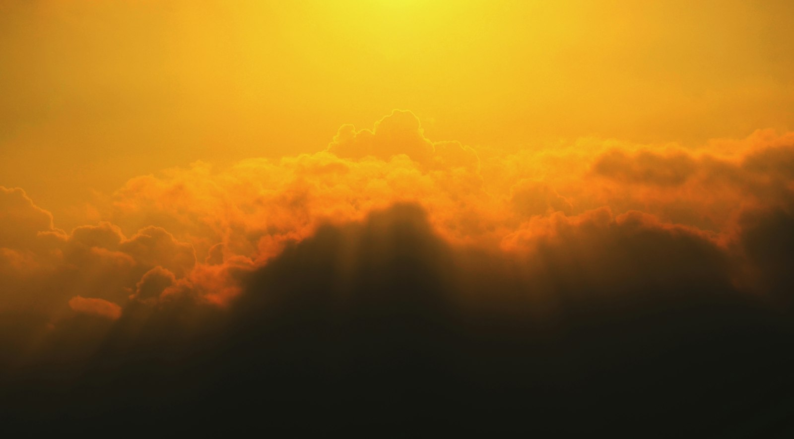 Sunlight breaking through clouds, a picture of Jesus in Revelation 1 coming with the clouds