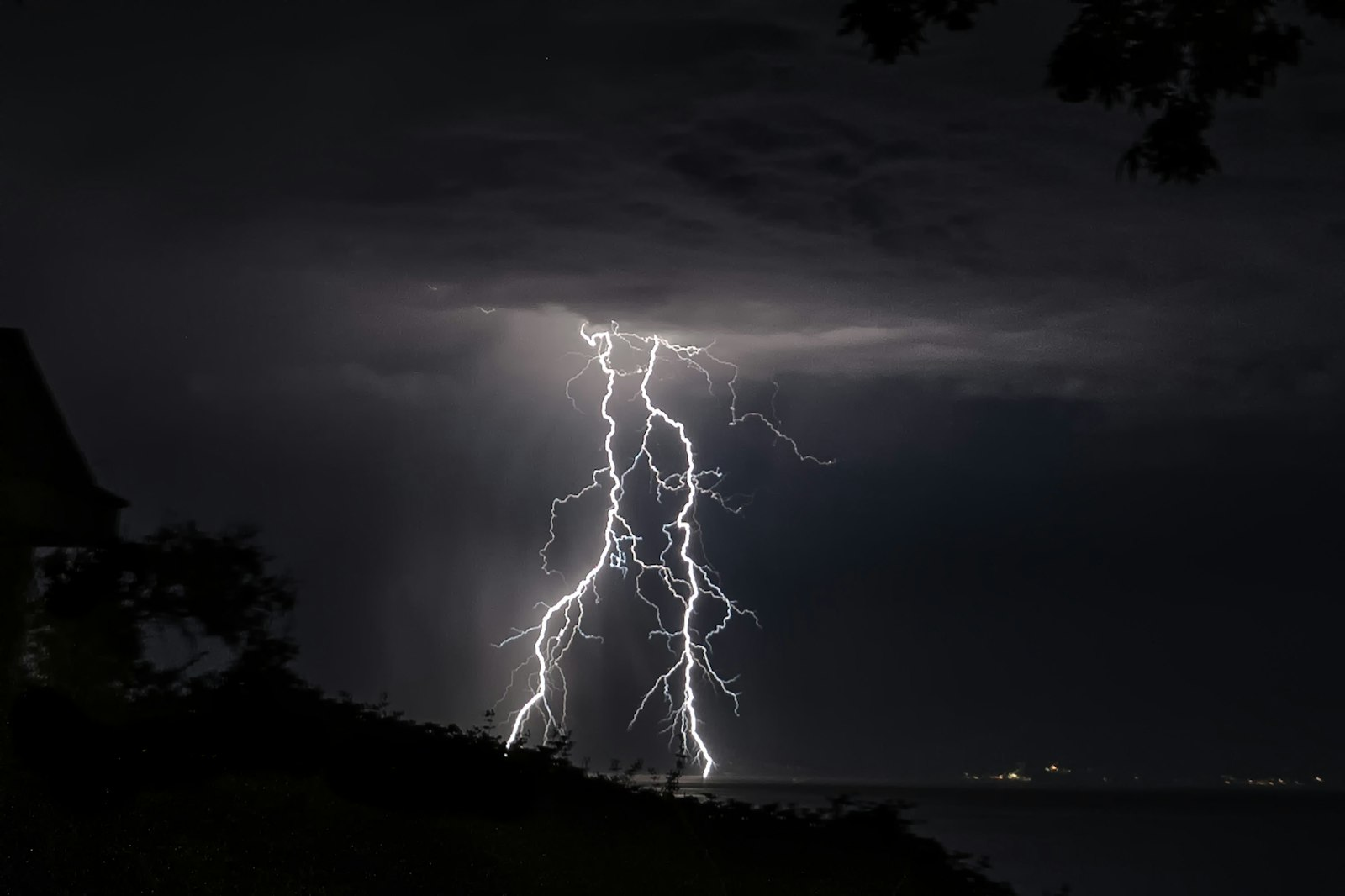 Lightning striking the sea under dark storm clouds, a picture of the seven bowls of Revelation