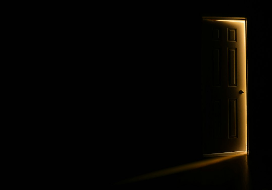 A door left slightly open with light falling through, a picture of the Father's welcome and our identity in Christ