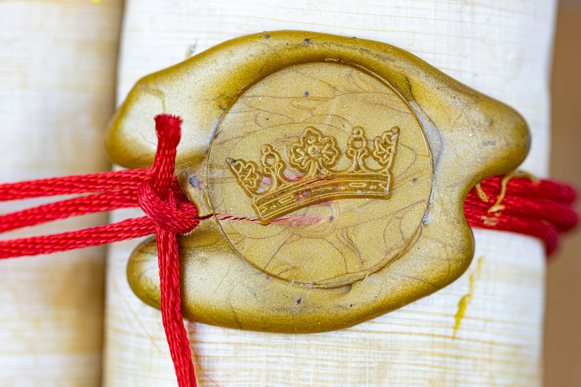 A sealed scroll tied with red cord, picturing the seven seals of Revelation 6