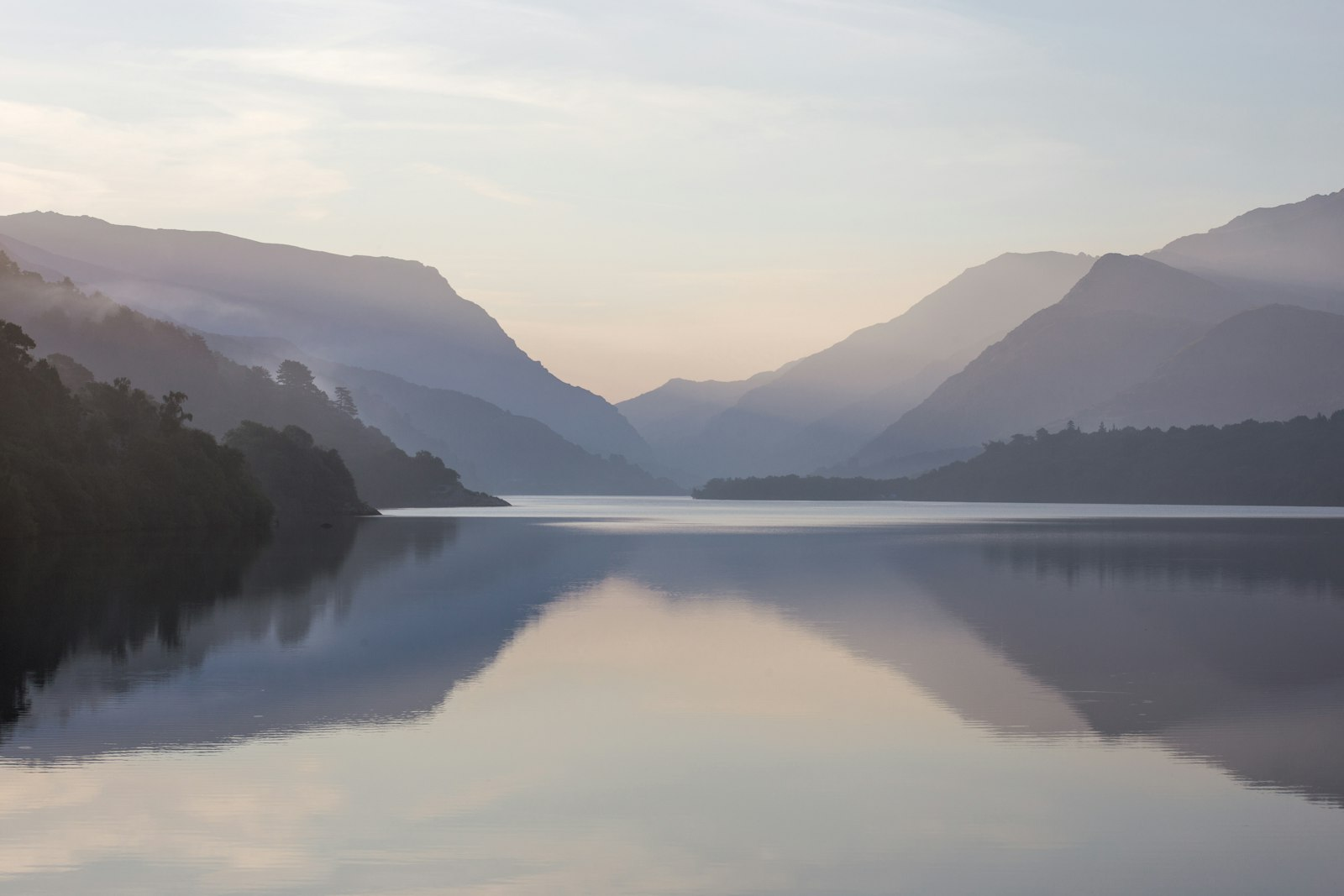 A still lake below mountains on a calm morning, a quiet place to learn how to pray and listen to God