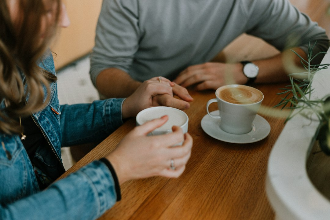 Two mugs of coffee on a table, a reminder that learning how to help someone who is suicidal starts with sitting down together