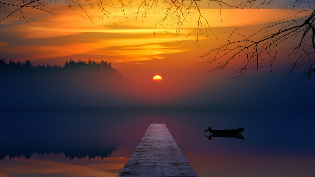 A wooden pier stretching into a misty lake under a warm sunrise, a quiet picture of hope for anyone looking for scripture for divorce healing